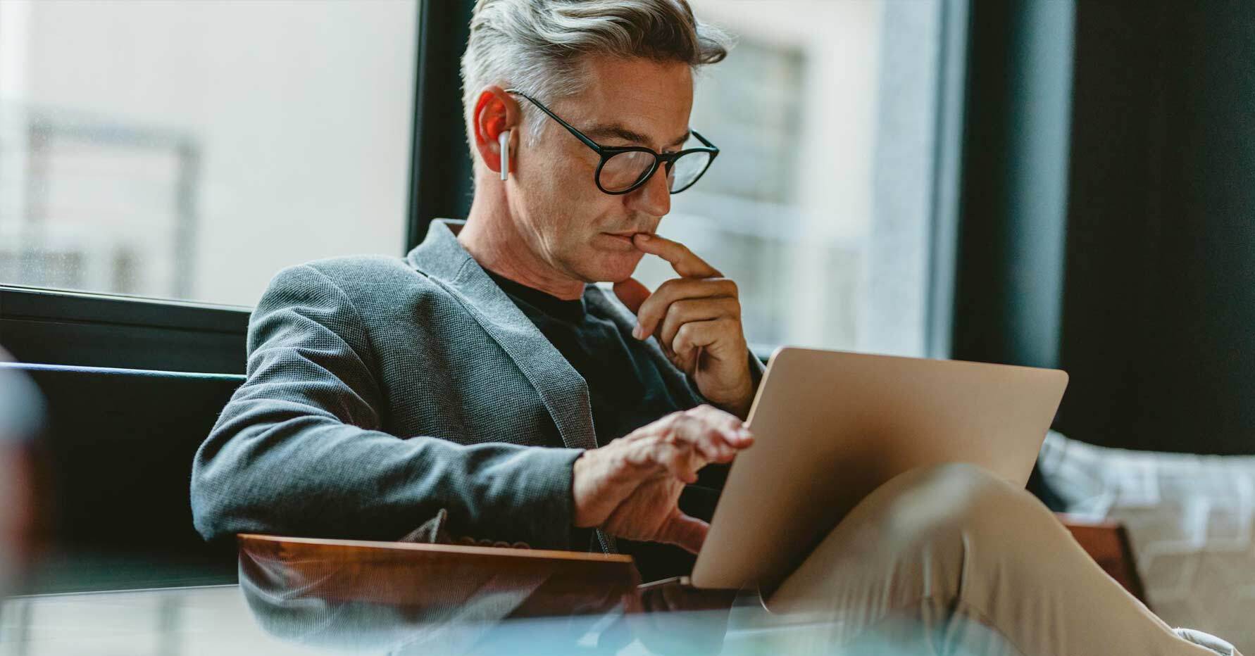 Photograph of a revenue leader looking at reports on a laptop