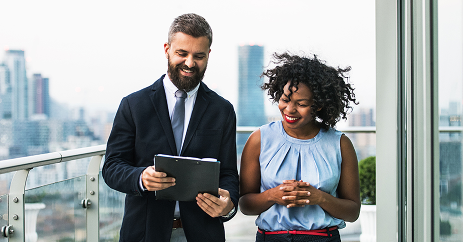 Photograph of two sales leaders looking at a report