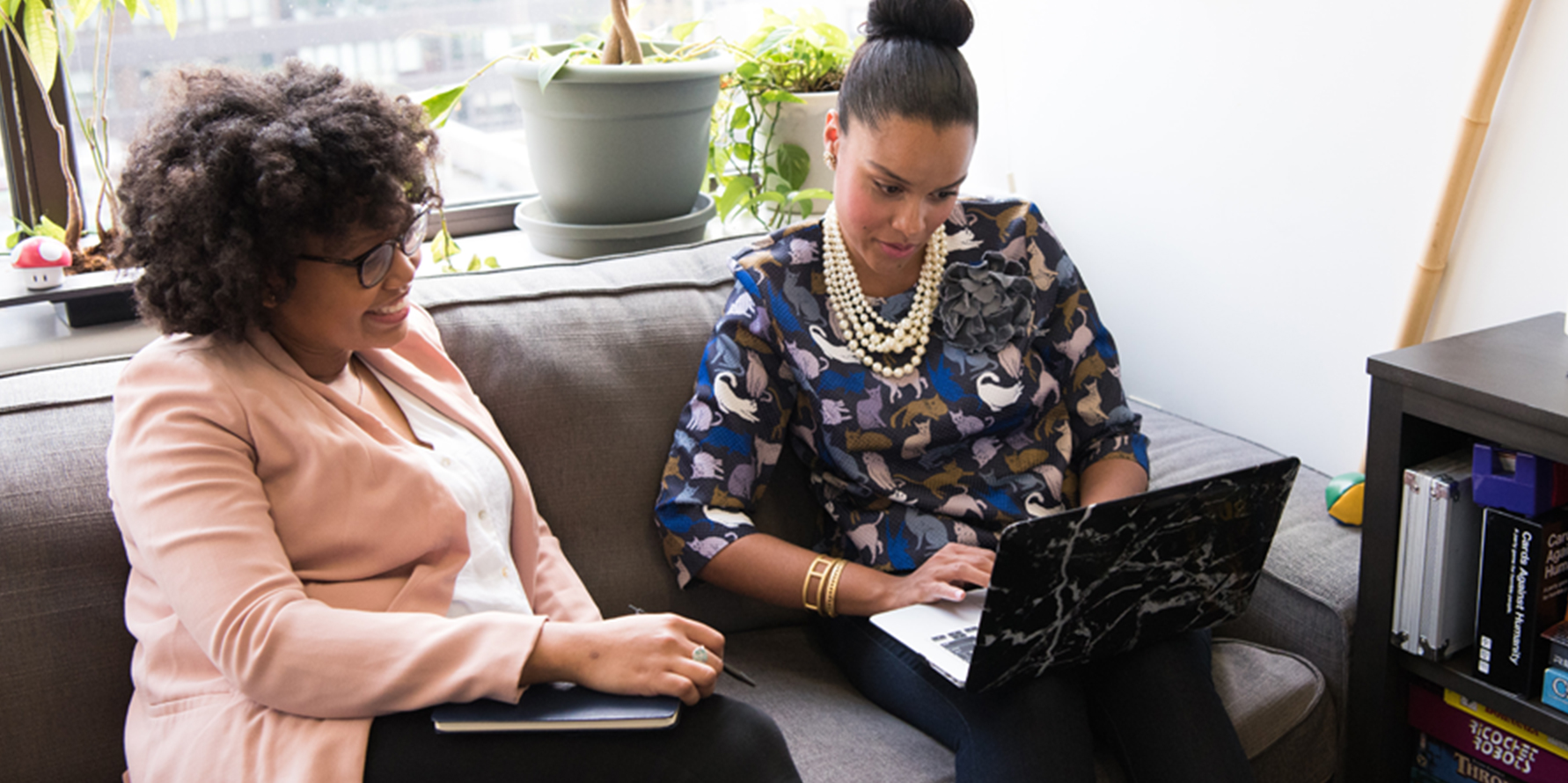 Photograph of two sales leaders discussing pipeline management training in front of a laptop