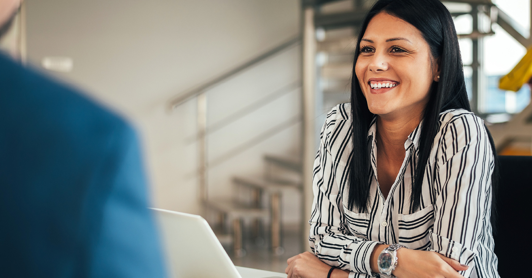 Photograph of a medical device salesperson talking to a healthcare professional