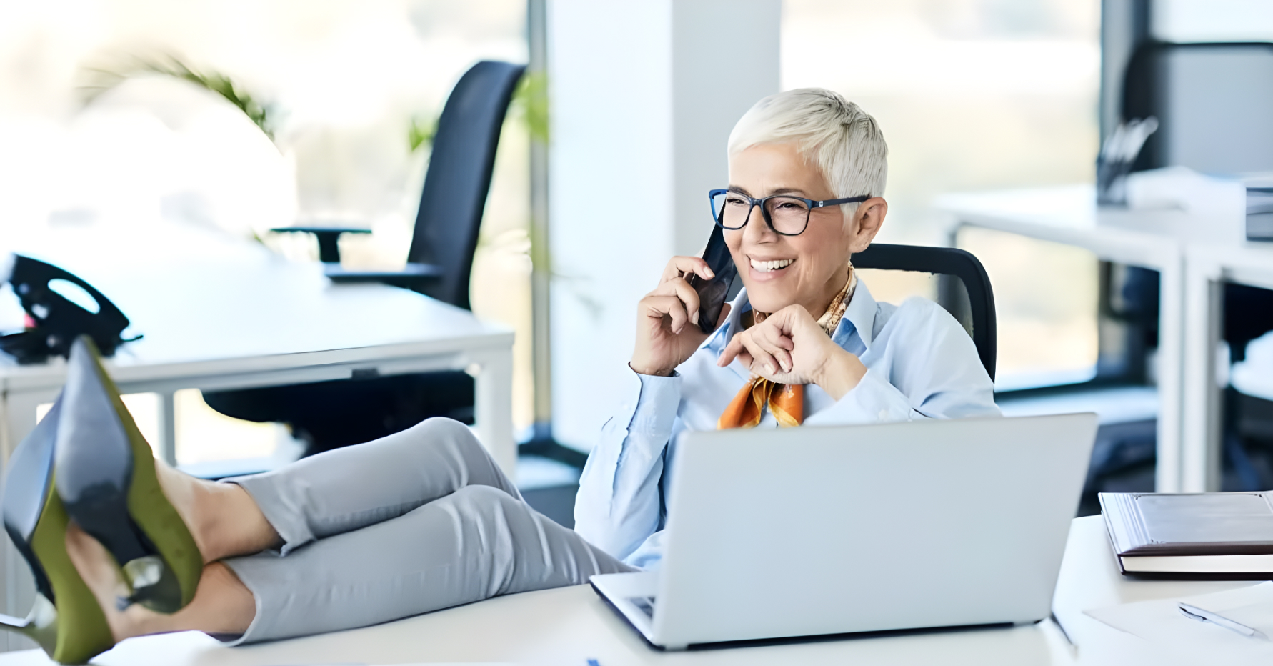 Photograph of a sales leader talking on the phone at a desk