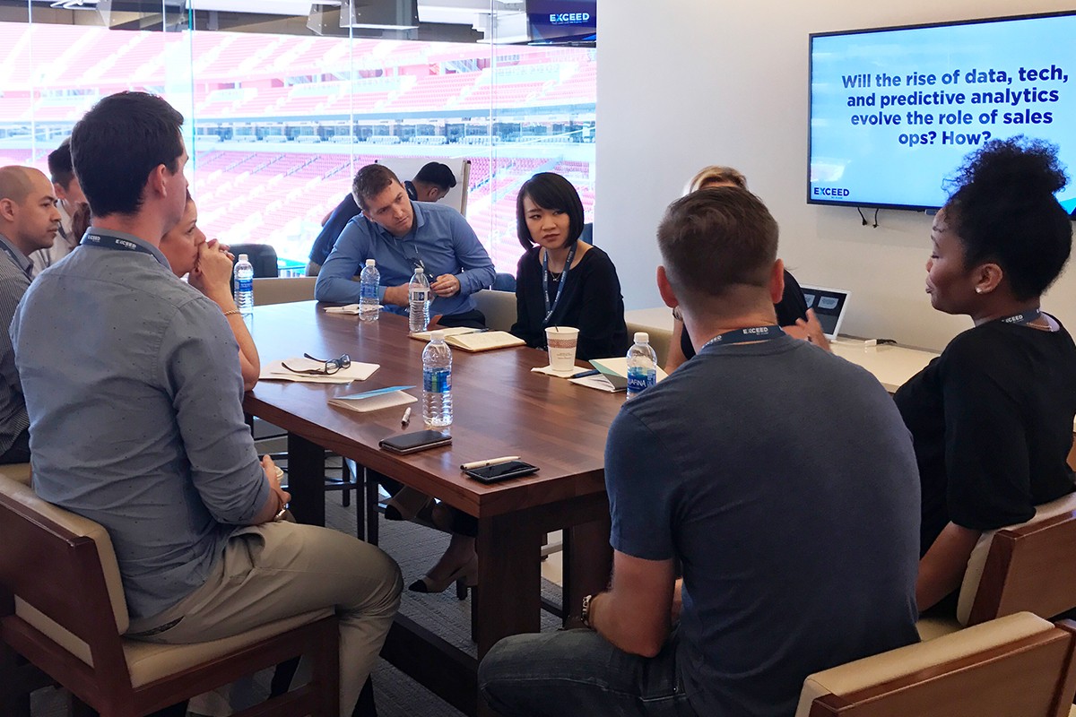 Photograph of a group of people in a breakout group at the EXCEED conference