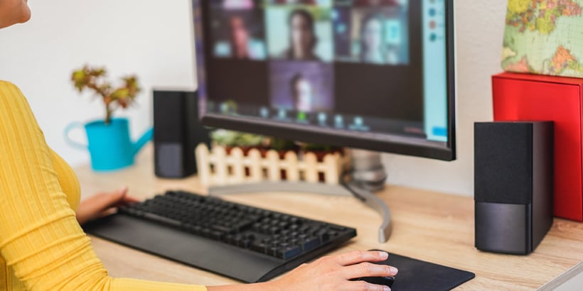 Photograph of a seller leading a sales call on a computer