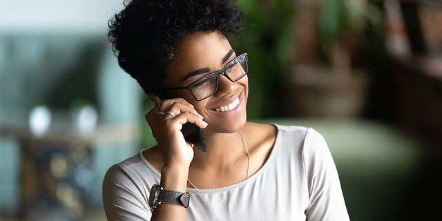 Photograph of a sales professional talking on a cell phone