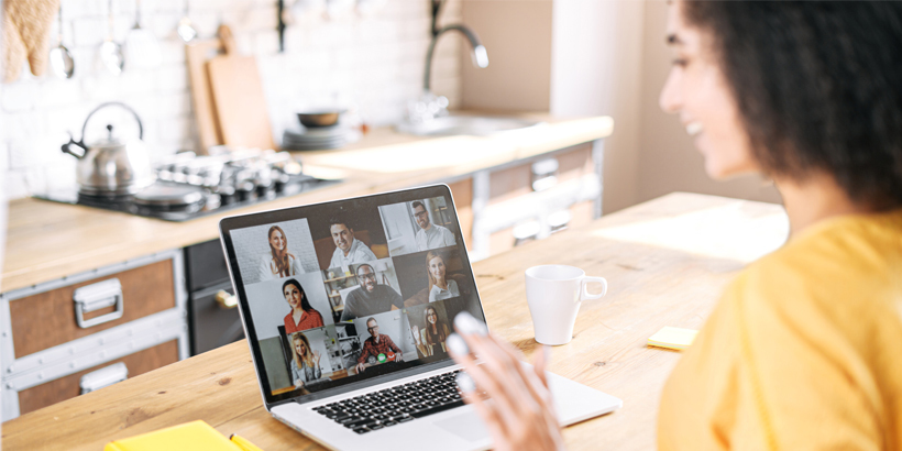 Photograph of a seller leading a virtual sales call on a laptop