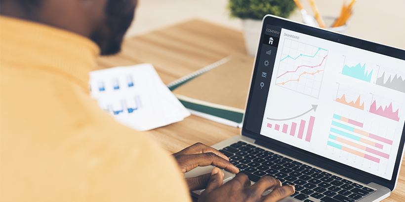 Photograph of a revenue leader looking at dashboards on a laptop