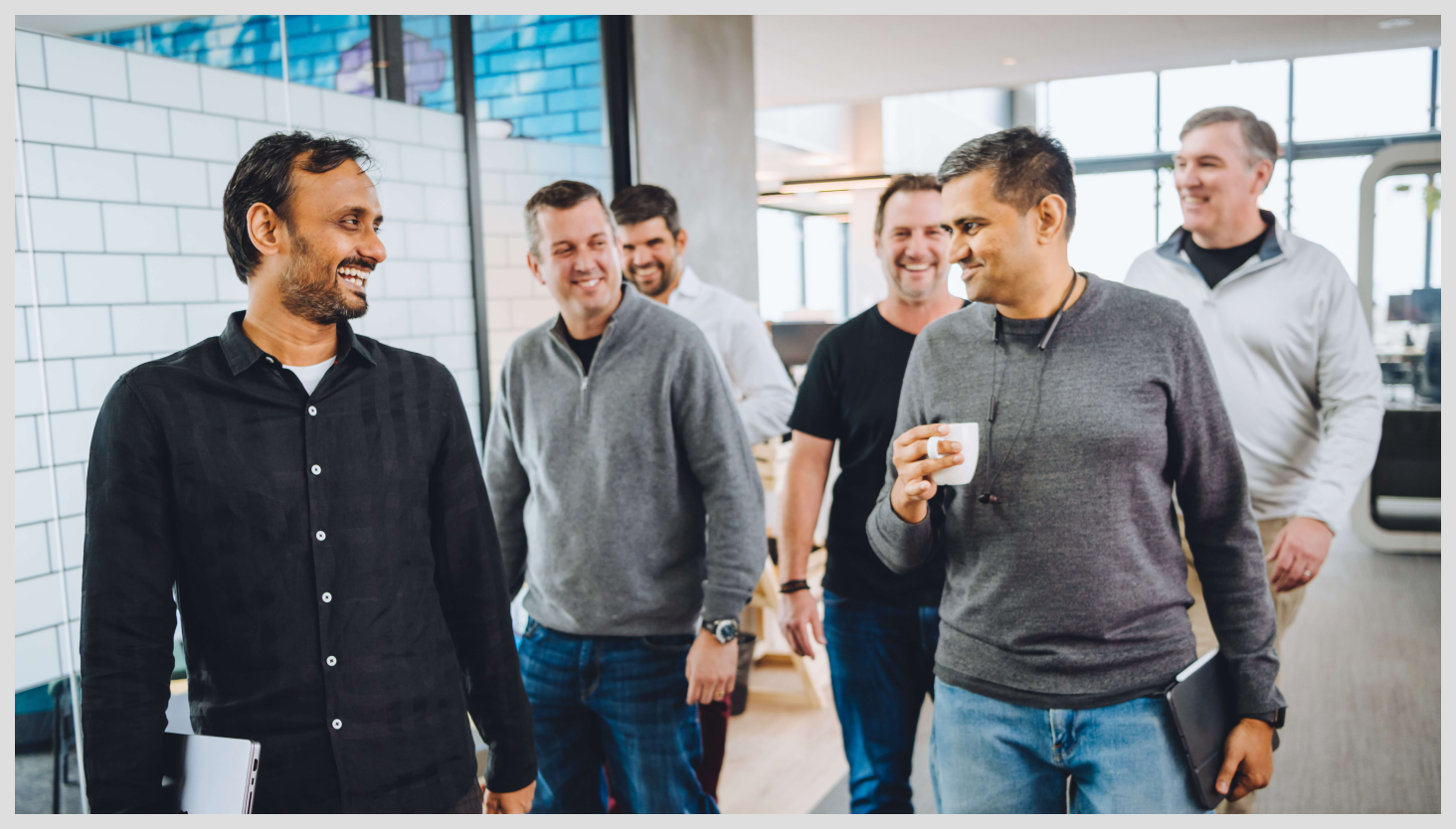 Group of men walking and laughing