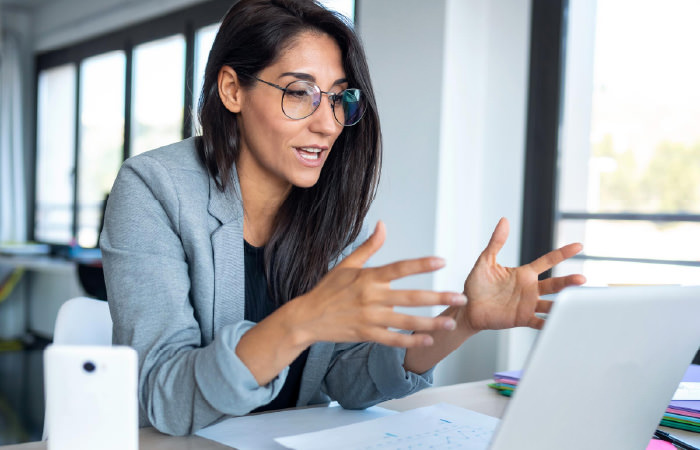 Photograph of a sales rep presenting to a prospective customer on a video call